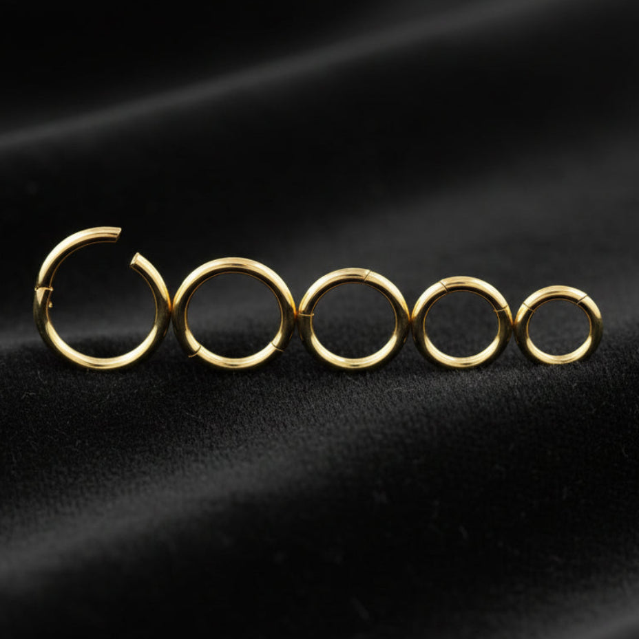 Set of gold hoop earrings on a white background