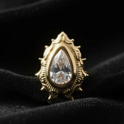 gold top with clear gem