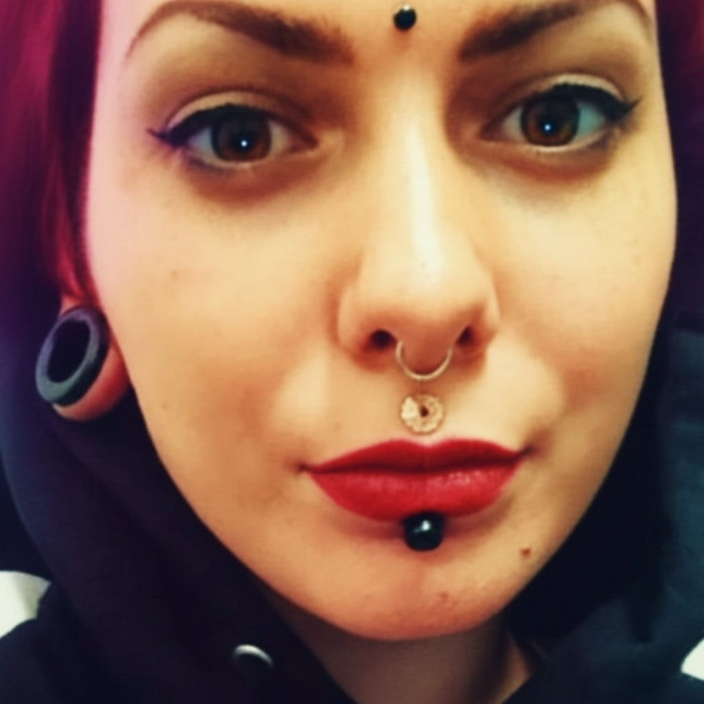 Person wearing a black hoodie with visible jewelry