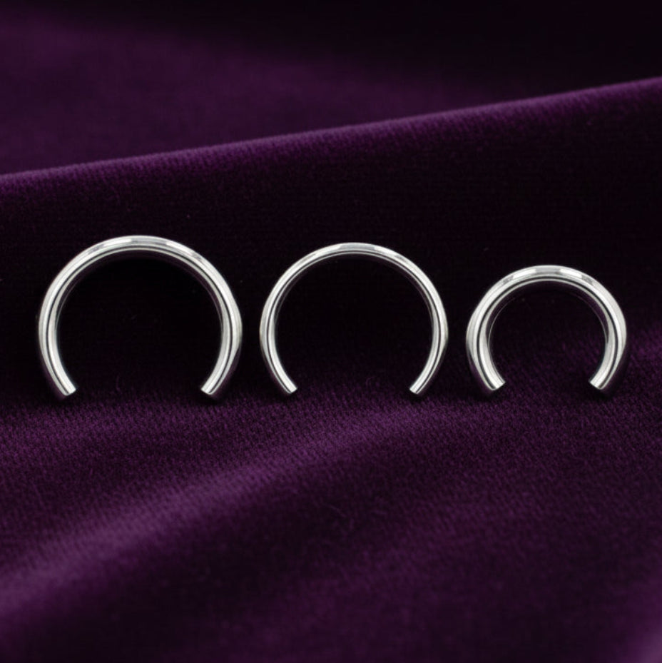 Three silver hoop earrings on a white background with text indicating barbells and ends sold separately.