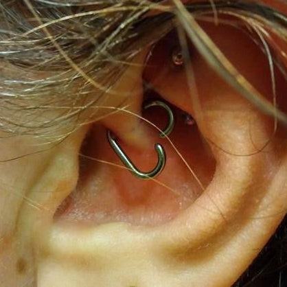 Close-up of an ear with multiple earrings