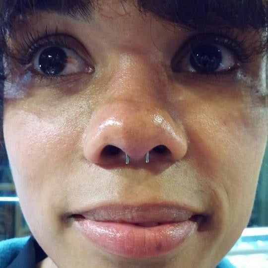 Close-up of a person with a visible mole on their face