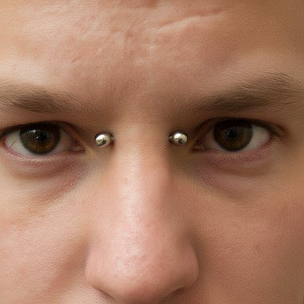Close-up of a person with facial piercings including a lip ring and nose ring.