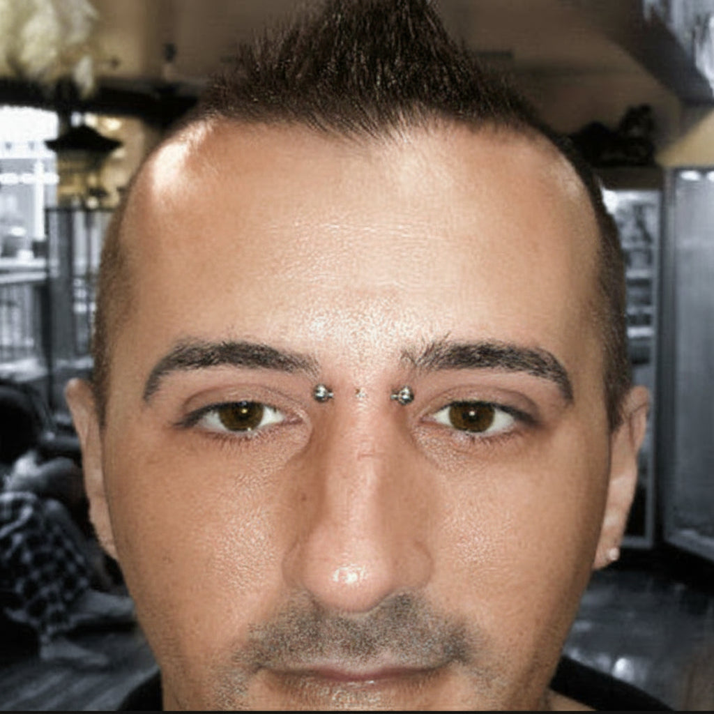 Close-up of a person with a nose ring in a blurred indoor setting