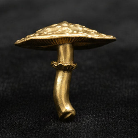 Gold-colored mushroom-shaped hook on a white background