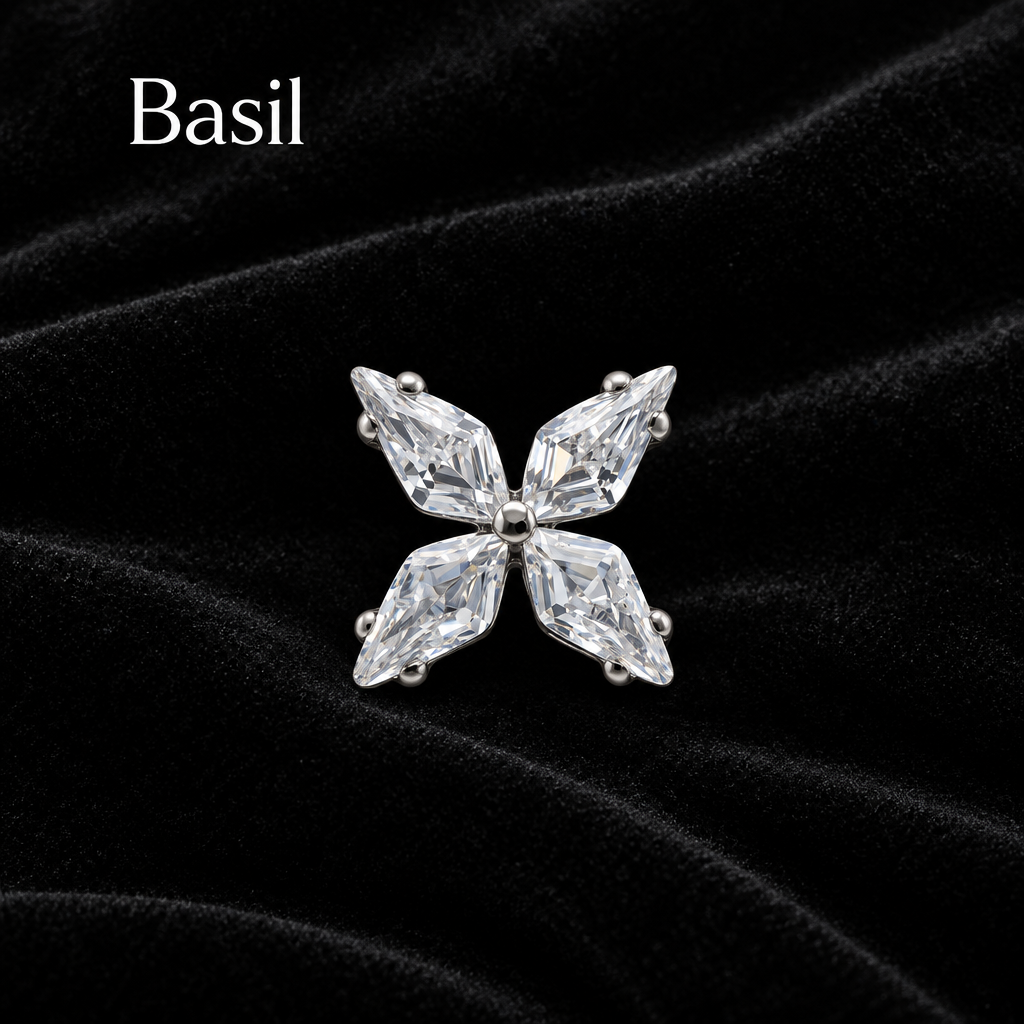 A silver-toned butterfly-shaped stud earring featuring four marquise-cut clear crystals, shown on a plain white background with the text 'Basil' in the top left corner.