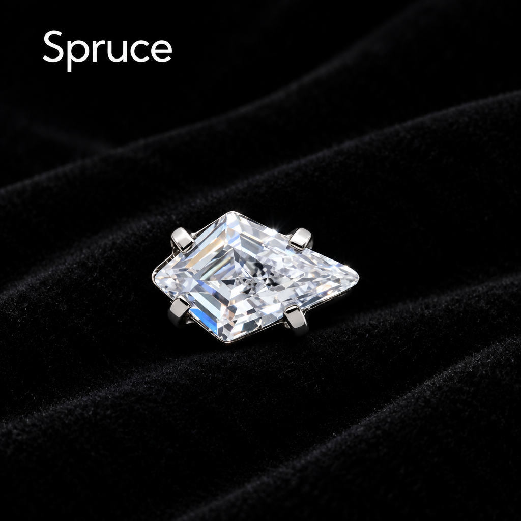 A single solitaire ring featuring a clear, faceted triangular gemstone in a silver-toned prong setting, shown on a clean white background with the brand name 'Spruce' in the top left corner.