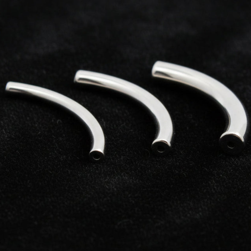 Three curved metal barbells on a white background with text indicating they are sold separately.