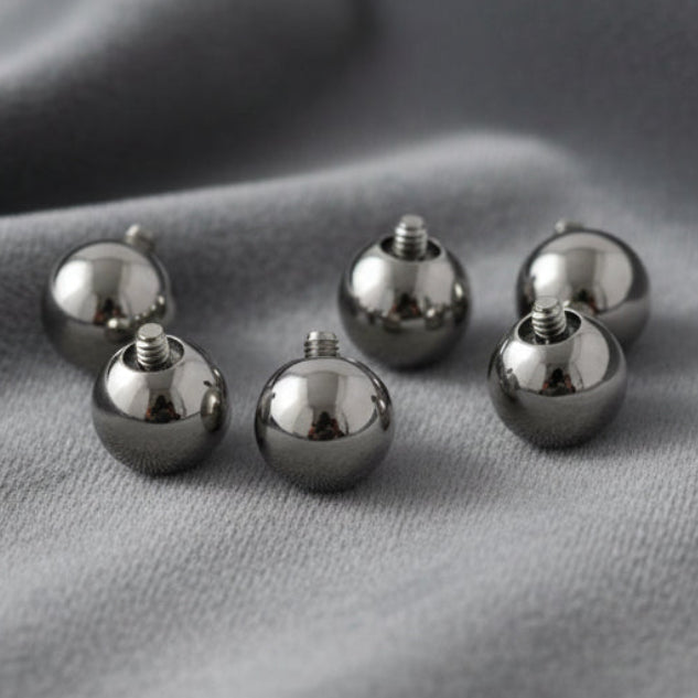 Set of six silver spherical objects on a white background