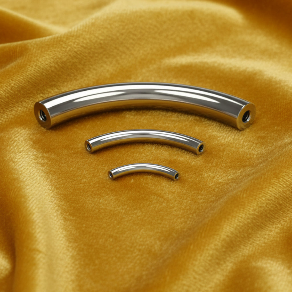 Metallic curved barbell components on a white background