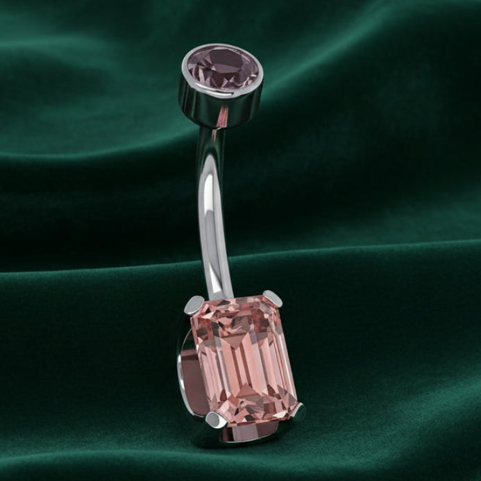 Belly button ring with pink gemstones on a white background