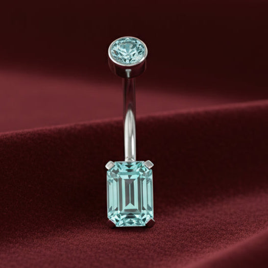 Belly button ring with a blue gemstone on a white background