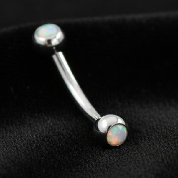 Silver barbell with opal stones on a white background