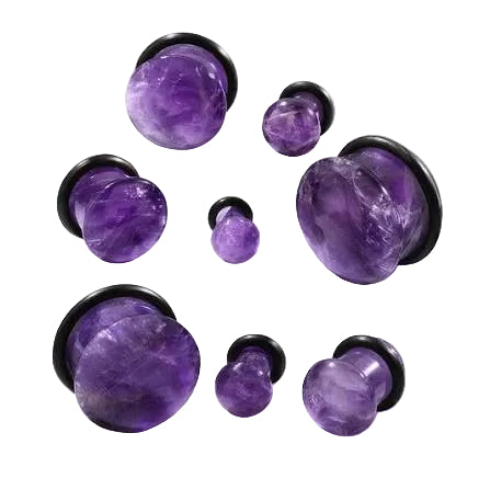 A set of purple amethyst tunnel plugs with black backing discs, arranged on a white marble surface.