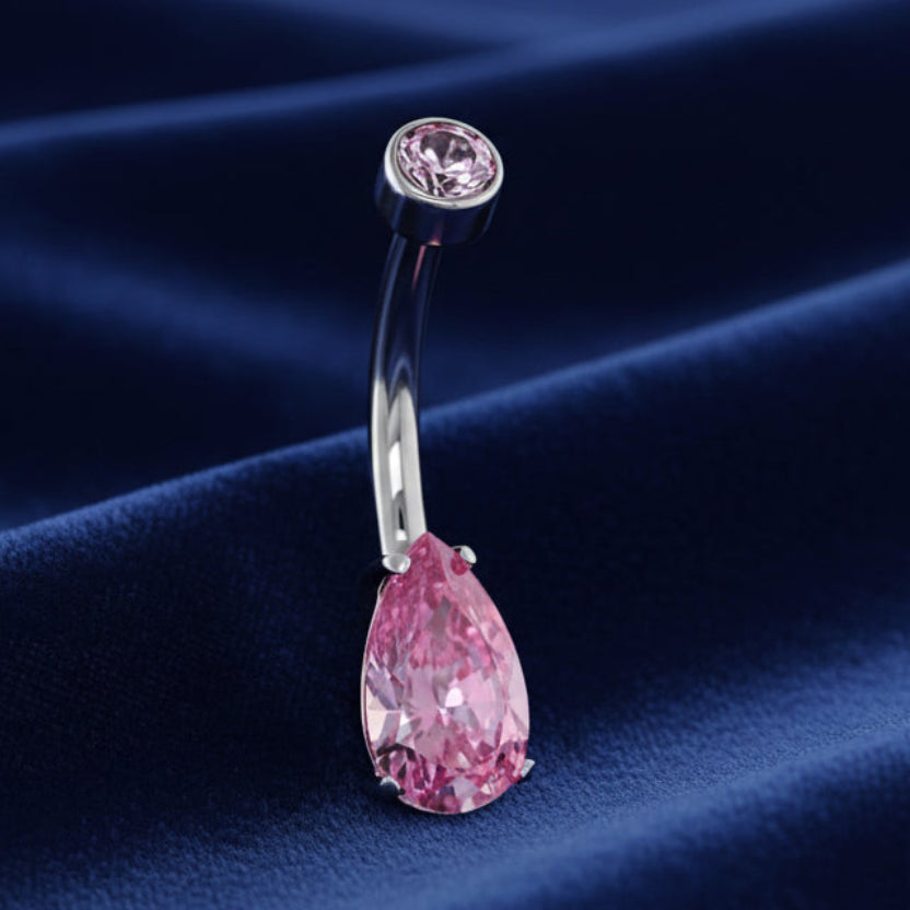Belly button ring with pink teardrop gem on a white background