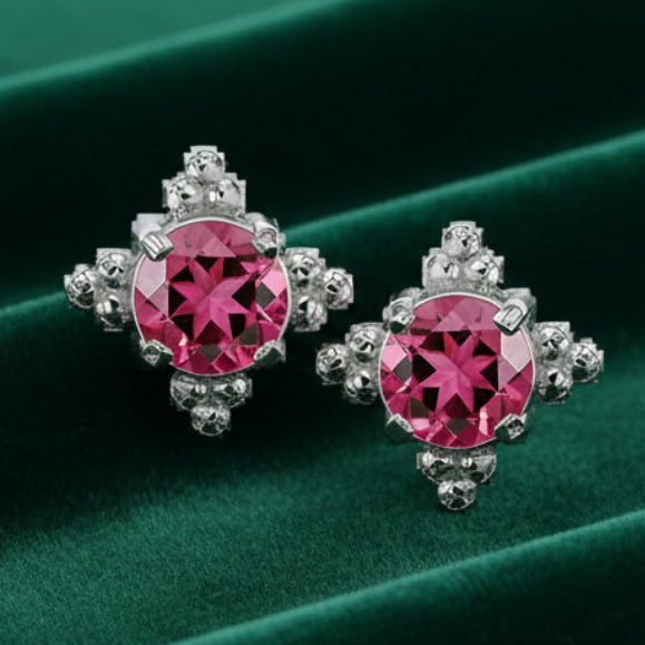 Pair of earrings with pink gemstones on a white background