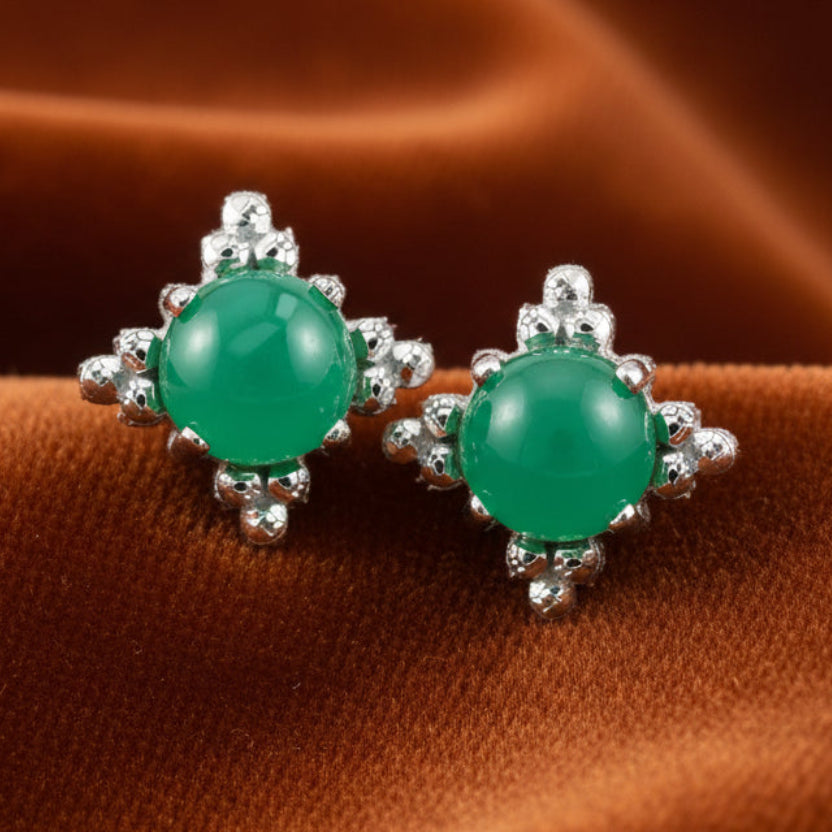 Pair of green earrings with silver accents on a white background